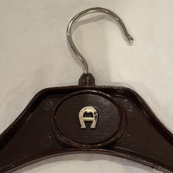 Standard size vintage 1970s Etienne AIGNER clothes hanger.  The brown/burgundy tone color that's typical of Aigner