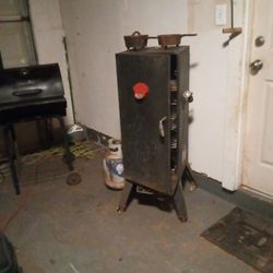 upright smoker with several trays inside comes with half a bottle of propane and has electric start ,