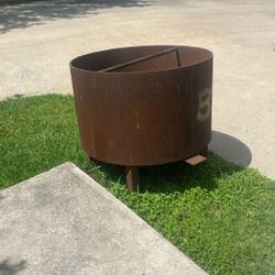 This item is a heavy-duty, industrial-style outdoor fire pit manufactured from weathering steel