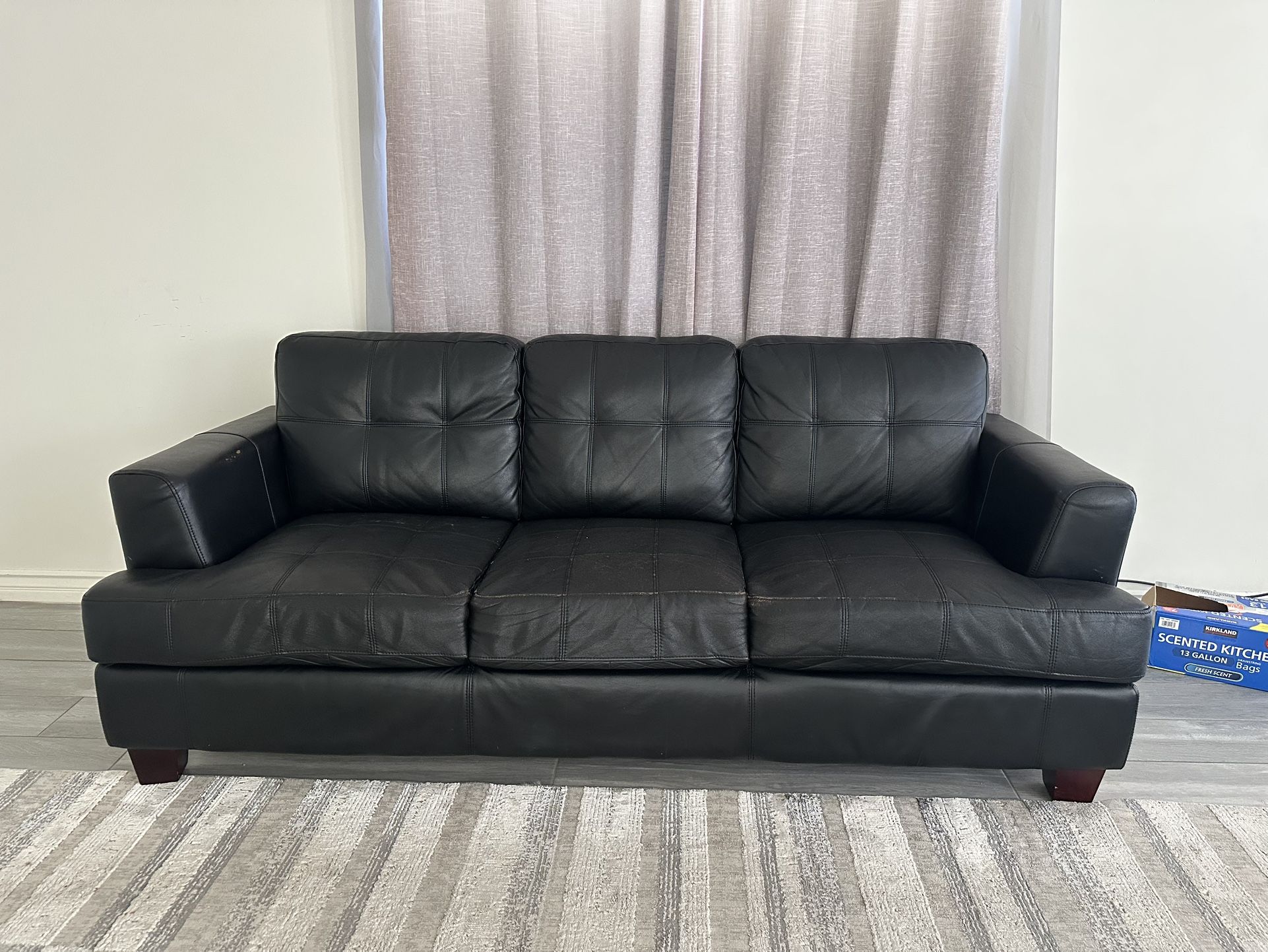 Two Matching Black “leather” Sofas
