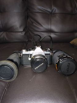 Pentax camera with 2 extra lenses.