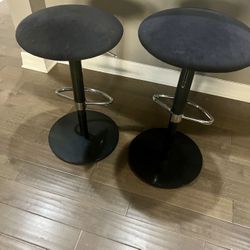 2 black Scan Design adjustable barstools