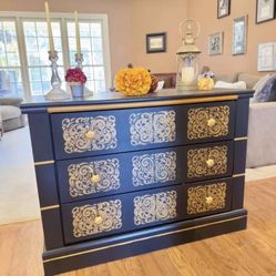 ELEGANT BLACK DRESSER AND GOLD ACCENTS WITH AN UNIQUE DESIGN. 