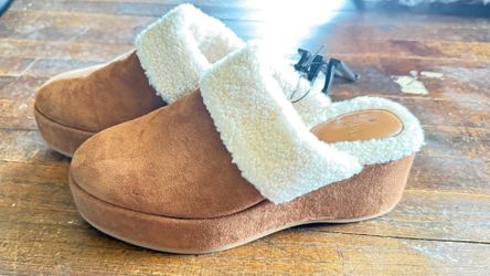 These are Time and Tru faux suede wedge clogs featuring a shearling-lined collar and a chunky platform sole.