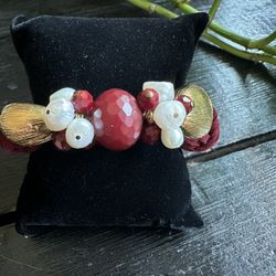 Red and gold beaded bracelet with pearls and gold leaf accents