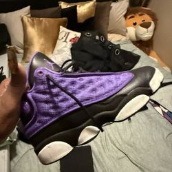     +1 This is a pair of Air Jordan 13 Retro "Purple Venom" sneakers. 