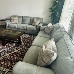 "Two three-person sofas in grey color.
