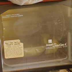 image shows a Ronco Compact Showtime+ Rotisserie & BBQ Oven. 
It is a countertop appliance designed to roast meats and vegetables. 
It features a roti