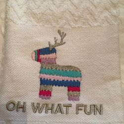 White hand towel with colorful reindeer design and 'Oh What Fun' text 16x26”