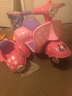 Minnie mouse motorcycle with a spot for a doll baby attached to it comes with the charger and all $25