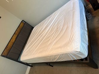 Full size bed frame with outlet, mattress, and mattress protector