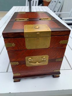 A vintage Chinese hardwood traveling vanity box with brass hardware.