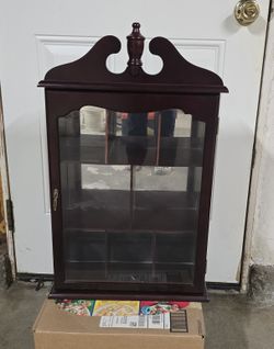 dark wood wall-hanging curio cabinet