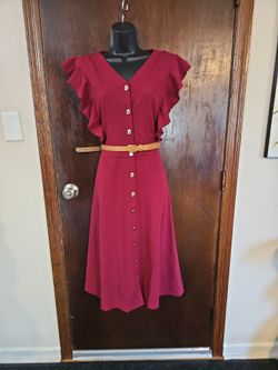 burgundy A-line midi dress features a button-down front, a V-neckline, and prominent ruffle flutter sleeves