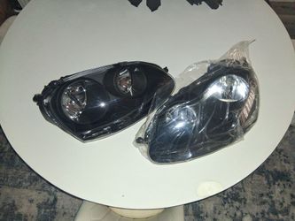 black housing headlight assemblies designed for the 2005-2010 Volkswagen Jetta, Golf, or Rabbit models.