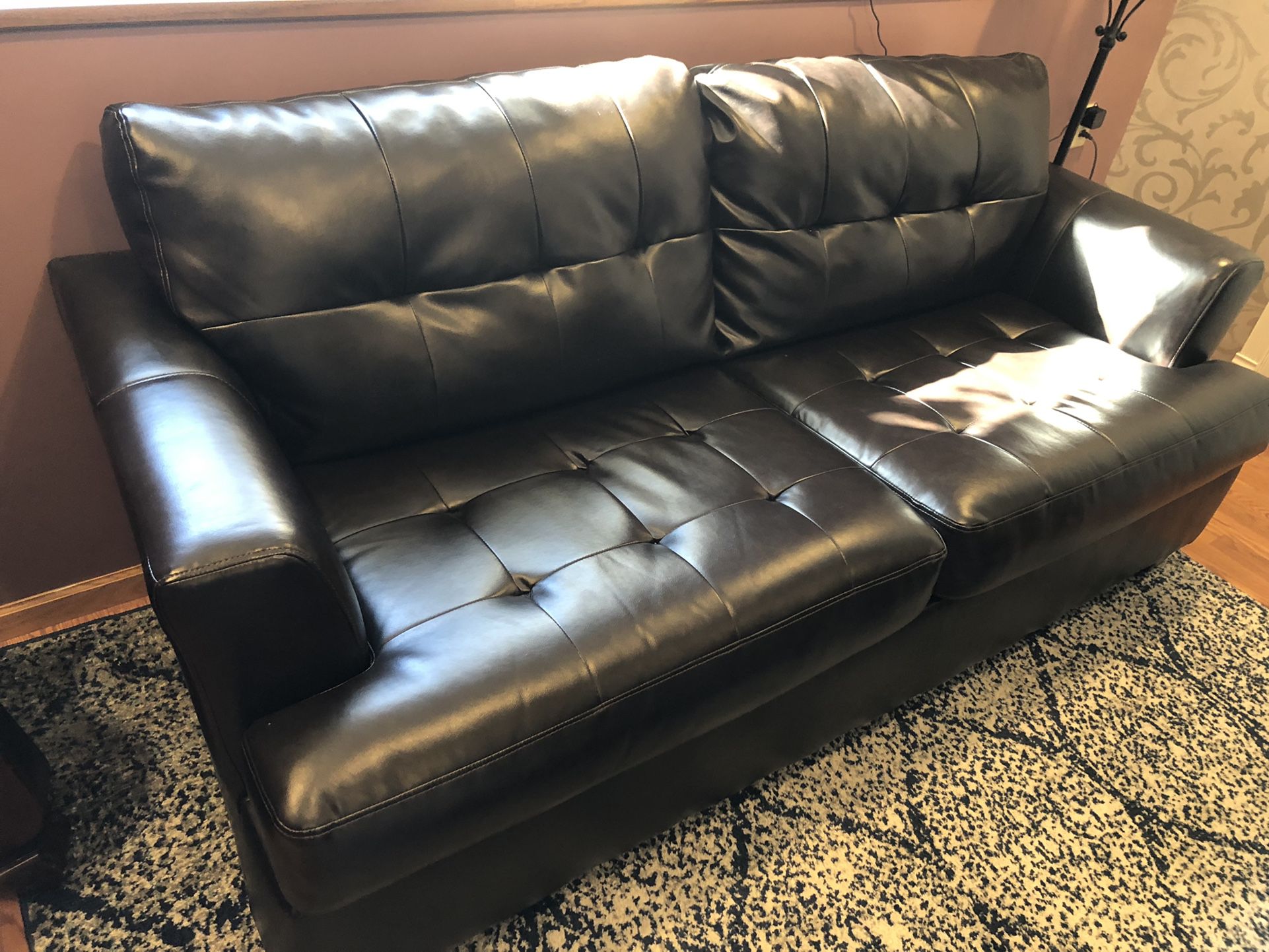 Leather couch, chair, and ottoman