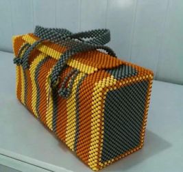 beaded bag with orange, yellow, and gray design.