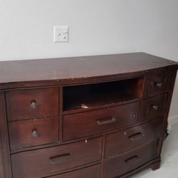 cherry wood dresser with a mix of knob and bar pull hardware. 