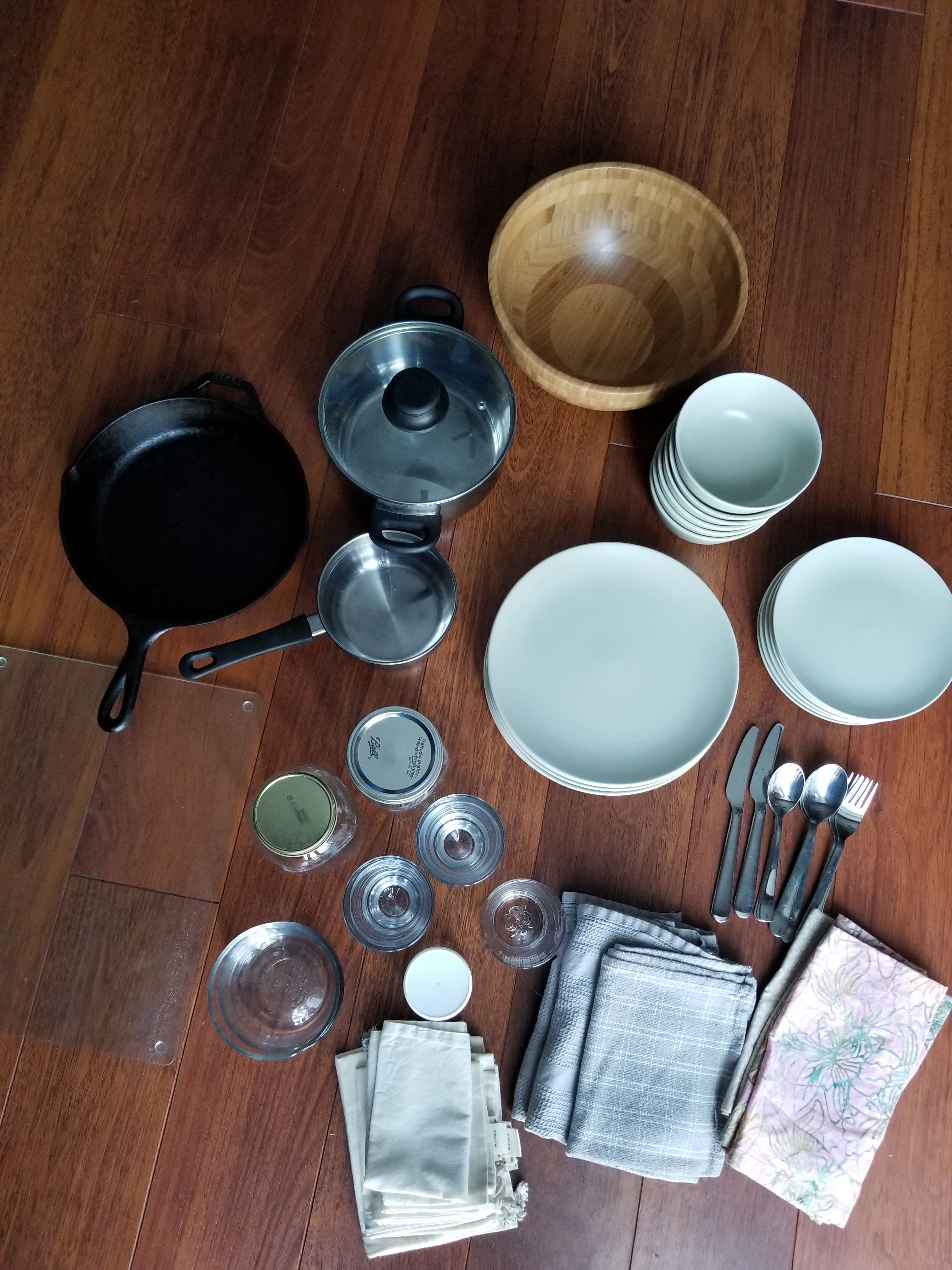 Kitchen things: dishes- plates, bowls, jars, cutting board, cast iron pan, towels etc