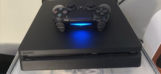 PS4 with controller and game