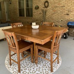 Wood table with 4 chairs. Bar height also has a leaf
