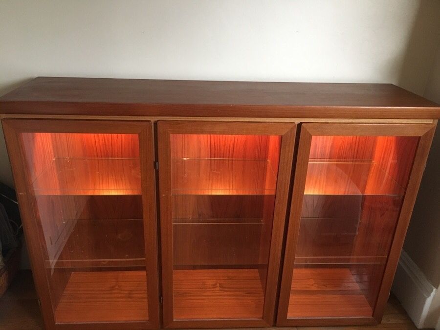 Solid wooden 3-door cabinet with adjustable glass shelves.