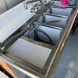 Sink tres compartimentos con llaves y válvulas