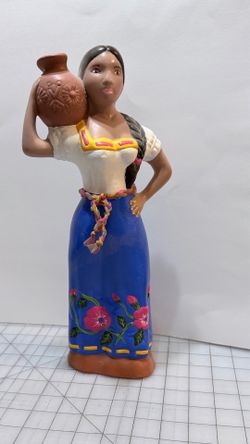 This hand-painted ceramic Lupita doll is a traditional Mexican folk art piece.