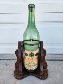 Empty Courvoisier Cognac Vintage Large Green Bottle on Wood Stand
