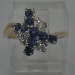 18kt yellow gold ring size 6 with 3 diamonds 0.25pts 9 sapphires 4 grams mint condition. 869659-8. 