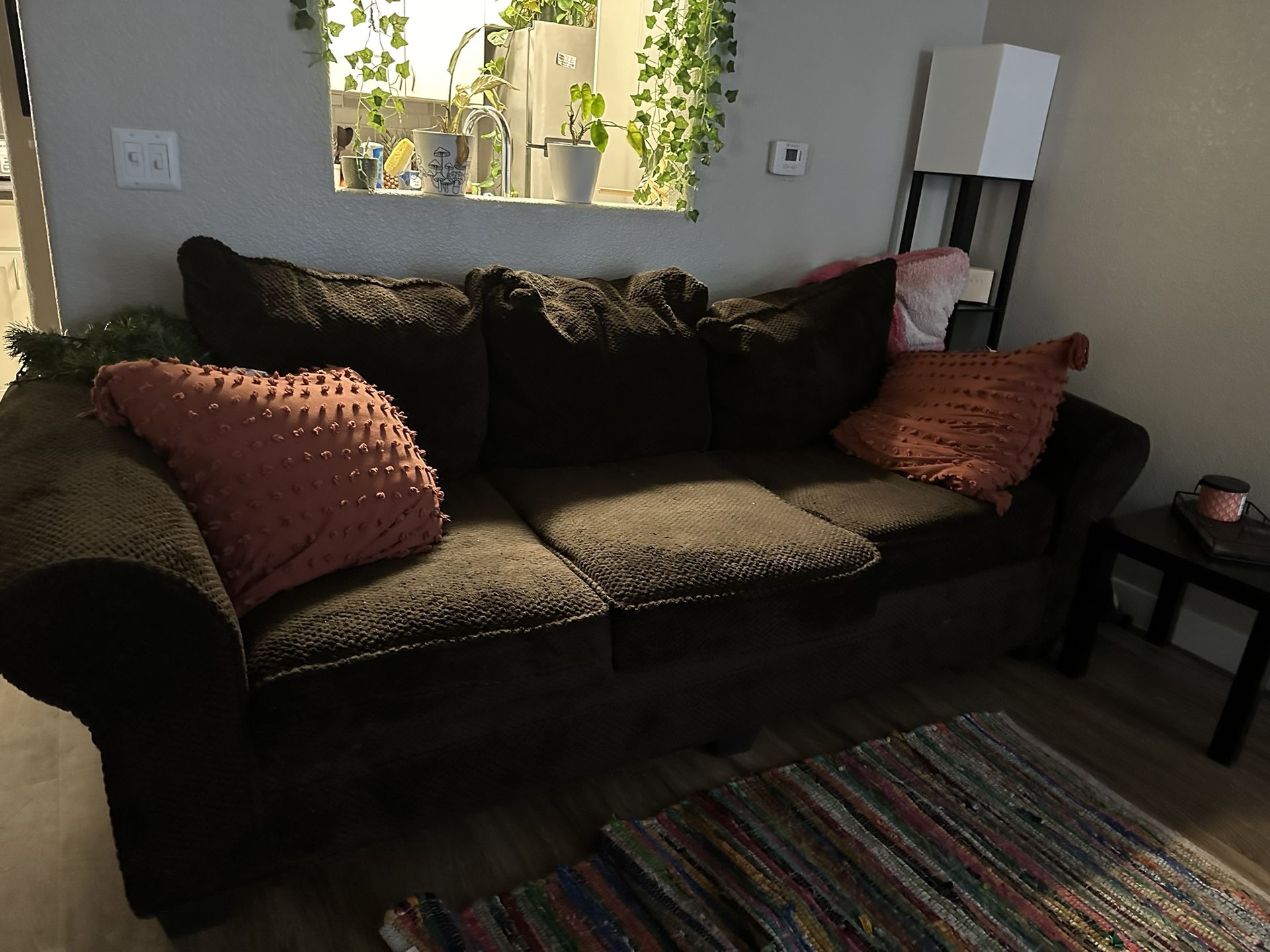 Brown couch with pillows 