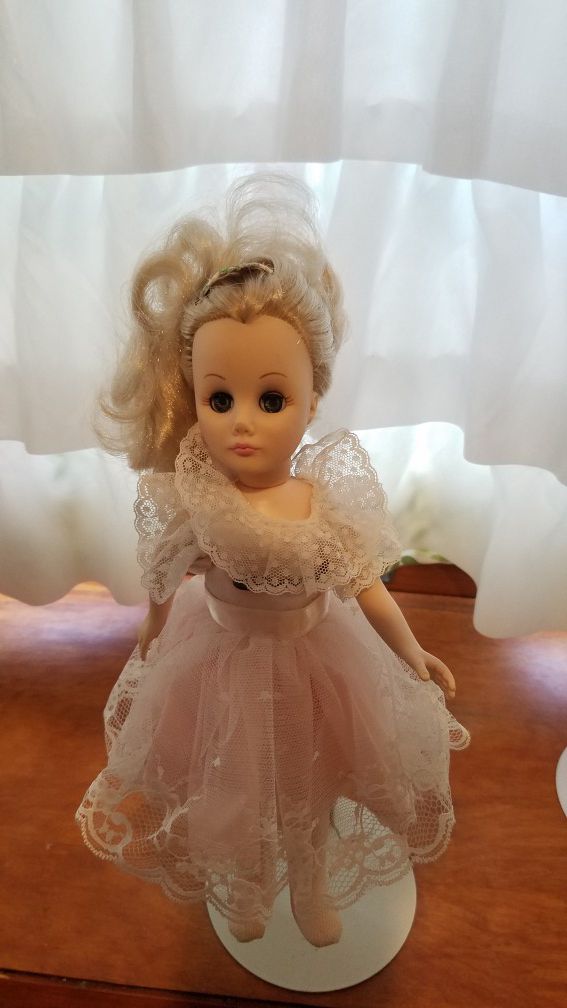 12" Doll with movable eyes and comes with doll stand