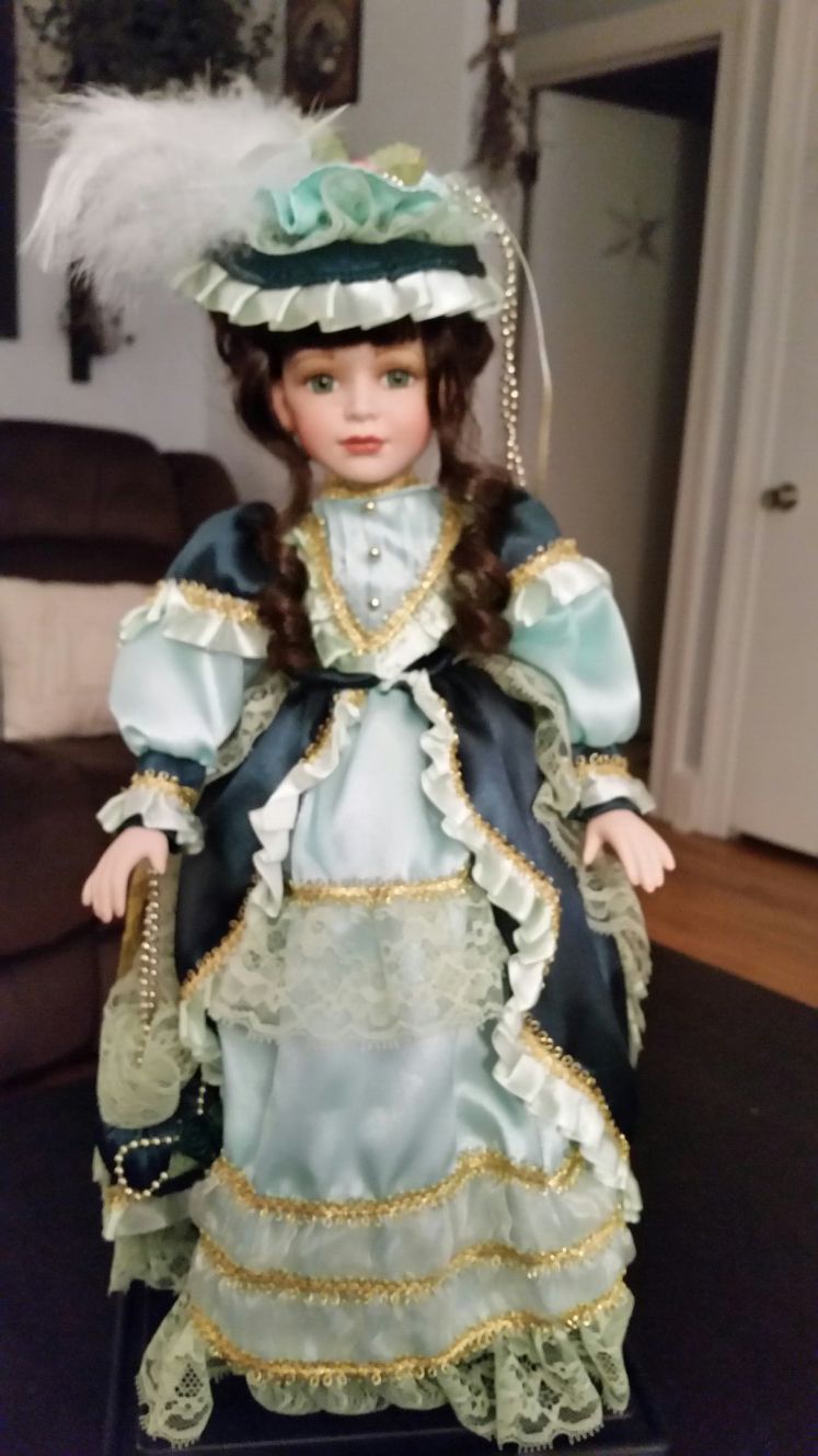 Porcelain doll in 2 tone green dress