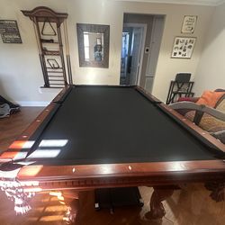 Pool table and chairs, stacking rack and pool sticks.