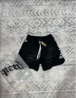 Black Godspeed shorts with white text on side