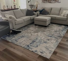 Two Couches, One Ottoman, and Area Carpet