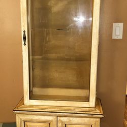 vintage or antique curio cabinet, with a distressed finish. 