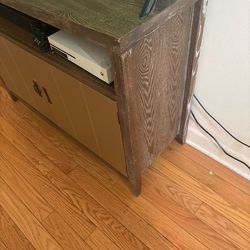 Wood tv stand with metal cabinet doors . Shelves inside