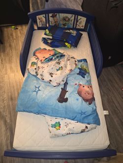 Toy Story Toddler bed with mattress, mattress protector, toy story sheets, and toy story curtains!