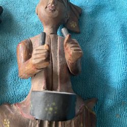 $60 to small wooden statues hang on a wall
