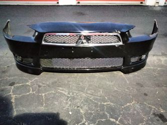 2008-2015 Mitsubishi Lancer complete front bumper with all the accessories OEM.