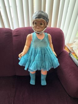 Cute vintage doll wearing a dress