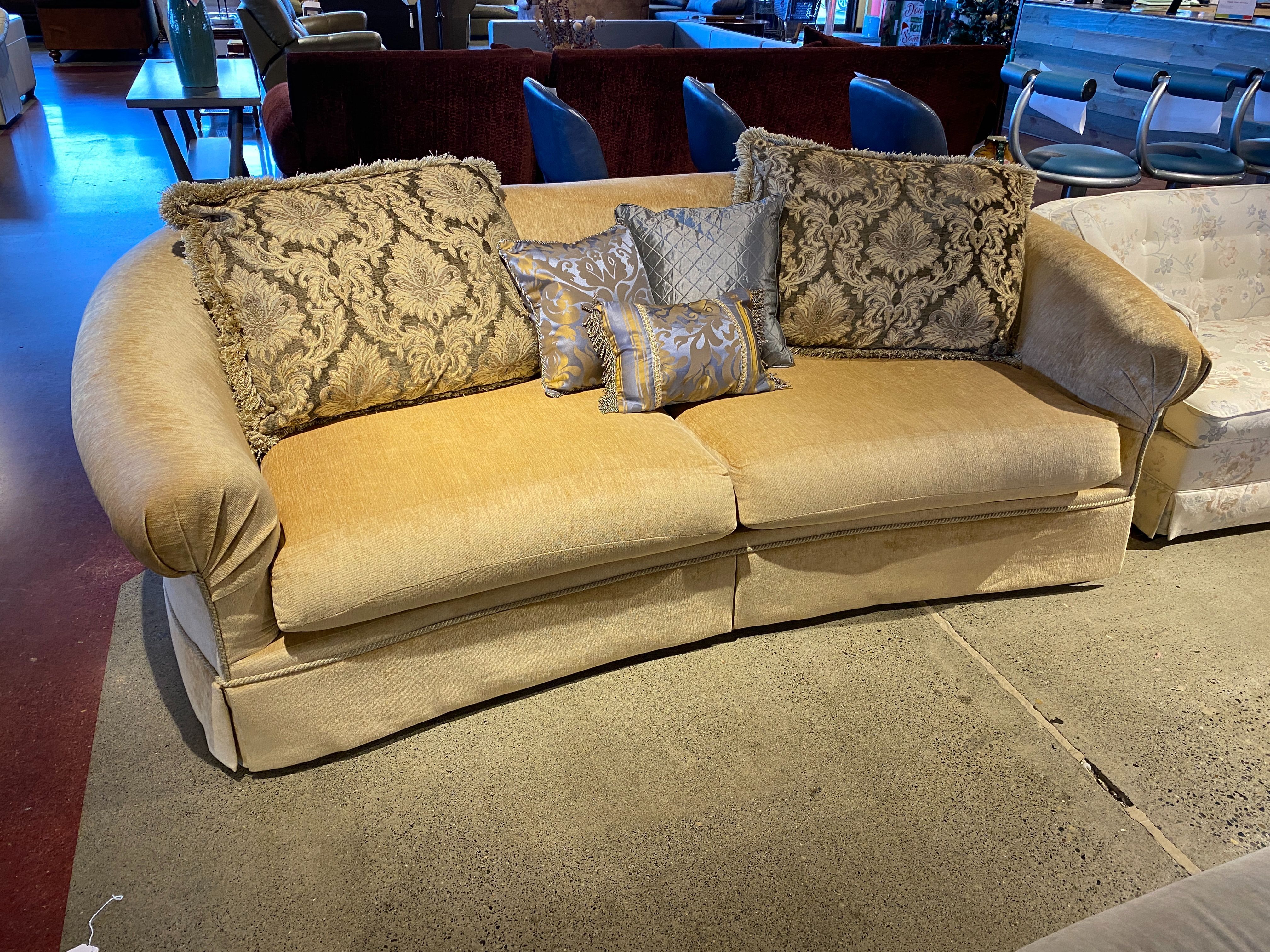 Gold Curved Sofa with Decorative Throw Pillows