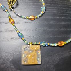 Beaded Necklace with Amber-Toned Square Pendant That Hides A Yellow Kitty.