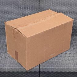 Clean medium size cardboard box and long strip of thick packing paper for shipping moving or storage