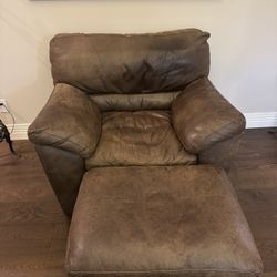 Oversized brown soft plush leather chair and ottoman set.