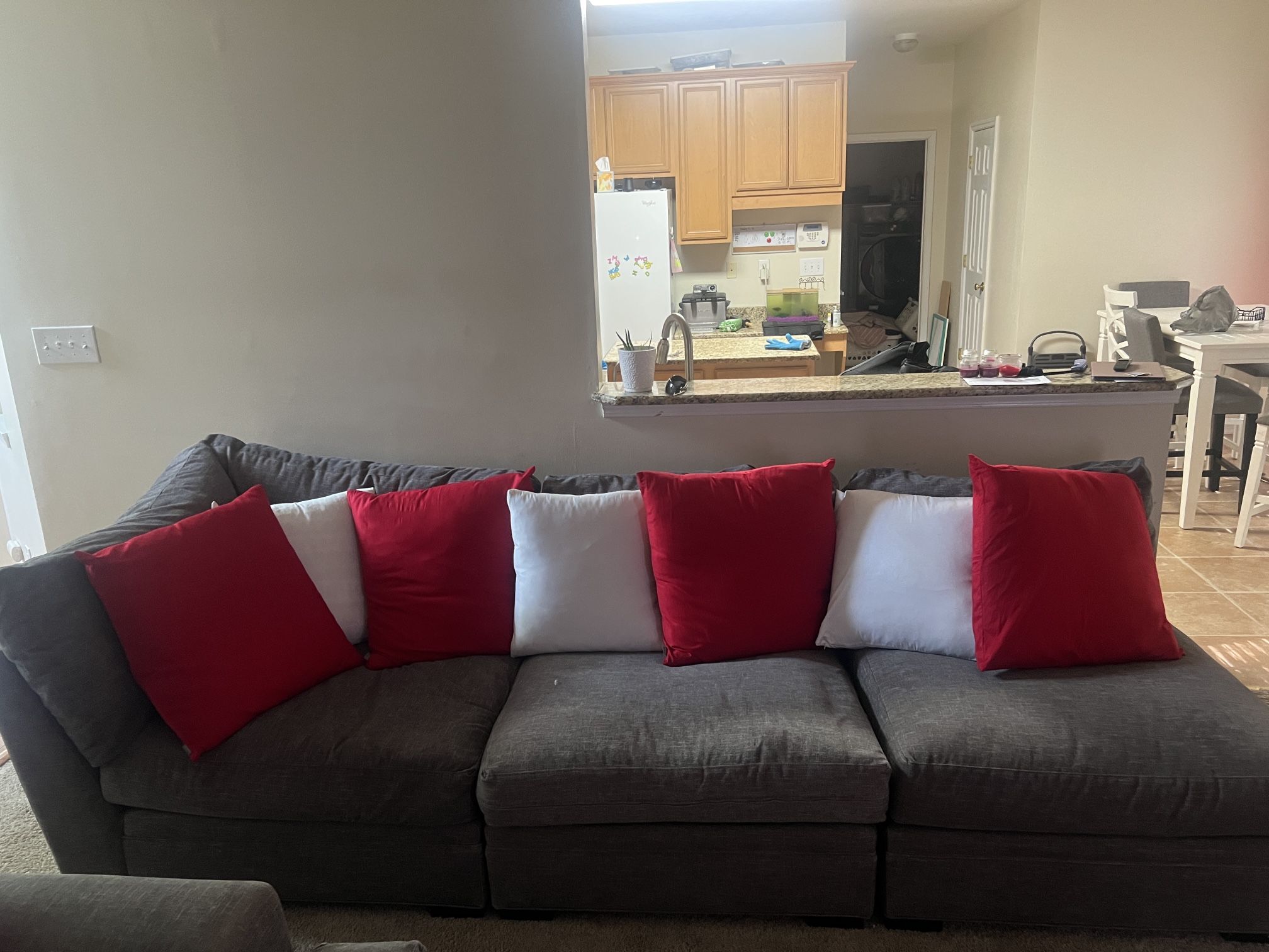 Gray Couch w/ Red & White Pillows + Ottoman