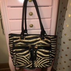Nicole Miller tan and black zebra print purse with lots of compartments. Like new. 13”x9” straps 11”