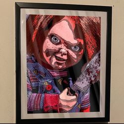 custom art piece of chucky from childs play on black frame