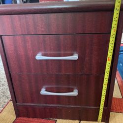 Selling a brown wooden bedside table with two drawers.. It's a sturdy piece and would be great next to a bed or as a small storage unit